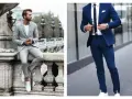 Un homme en costume bleu marine et baskets blanches, prêt pour une journée élégante mais décontractée.