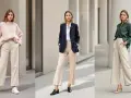 Trois femmes portent une tenue avec pantalon beige femme hiver : un pull rose, un blazer bleu marine, et une chemise verte.