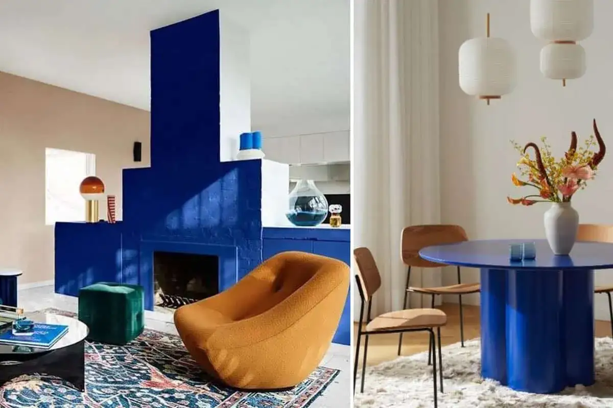 Un salon moderne avec une chemin&eacute;e audacieuse couleur bleu cobalt, un fauteuil orange et une table de salle &agrave; manger ronde bleu cobalt.